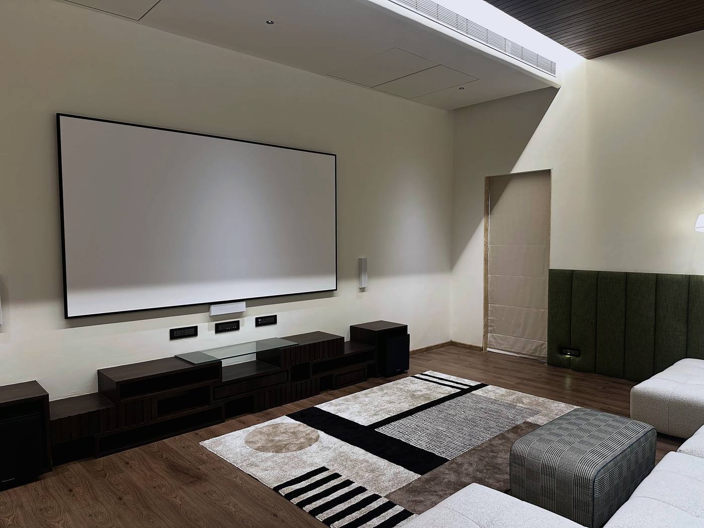 Calm, uncluttered screen wall in the dedicated home theatre