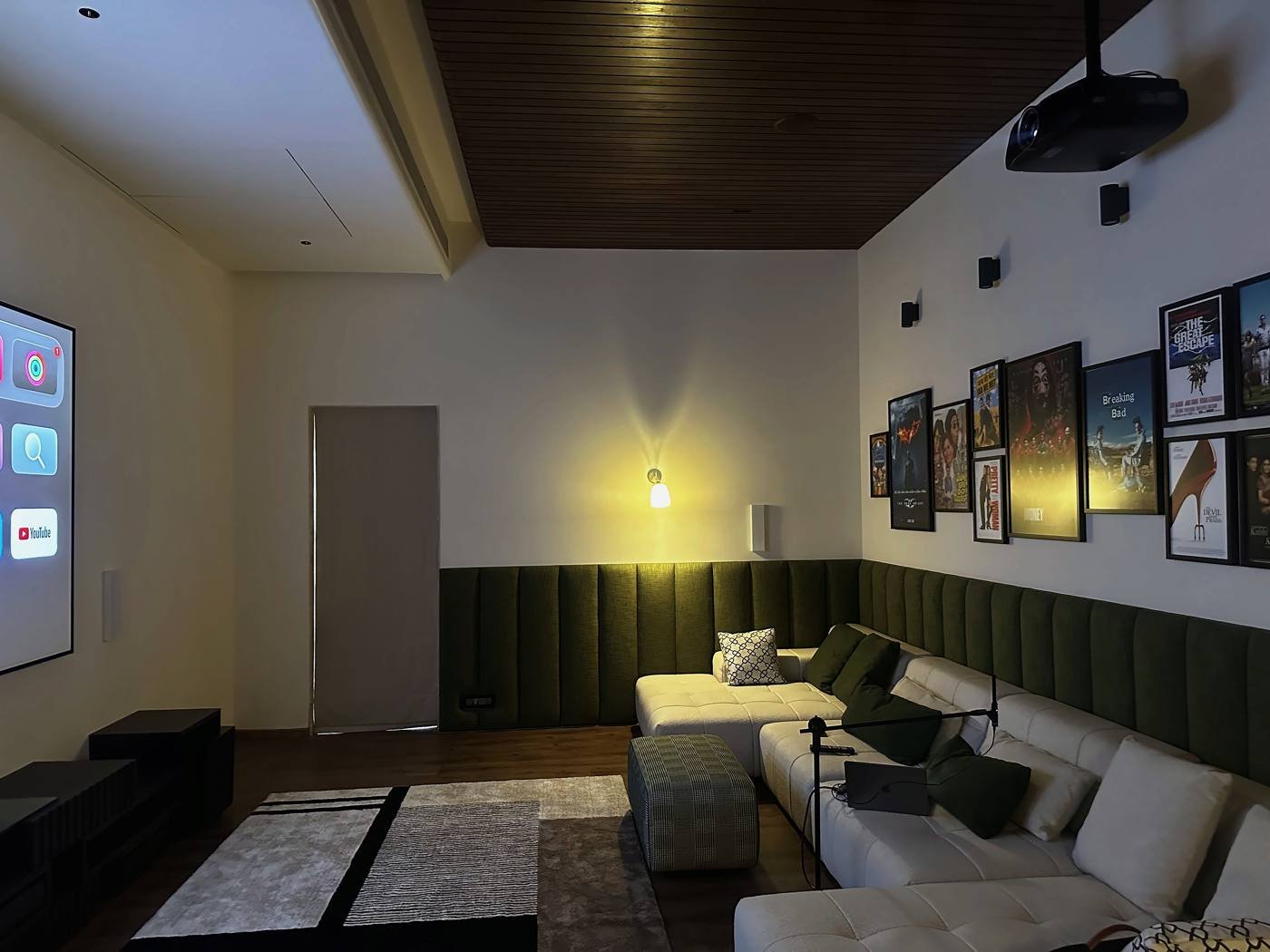Home theatre with olive wall panels, timber ceiling and modular seating