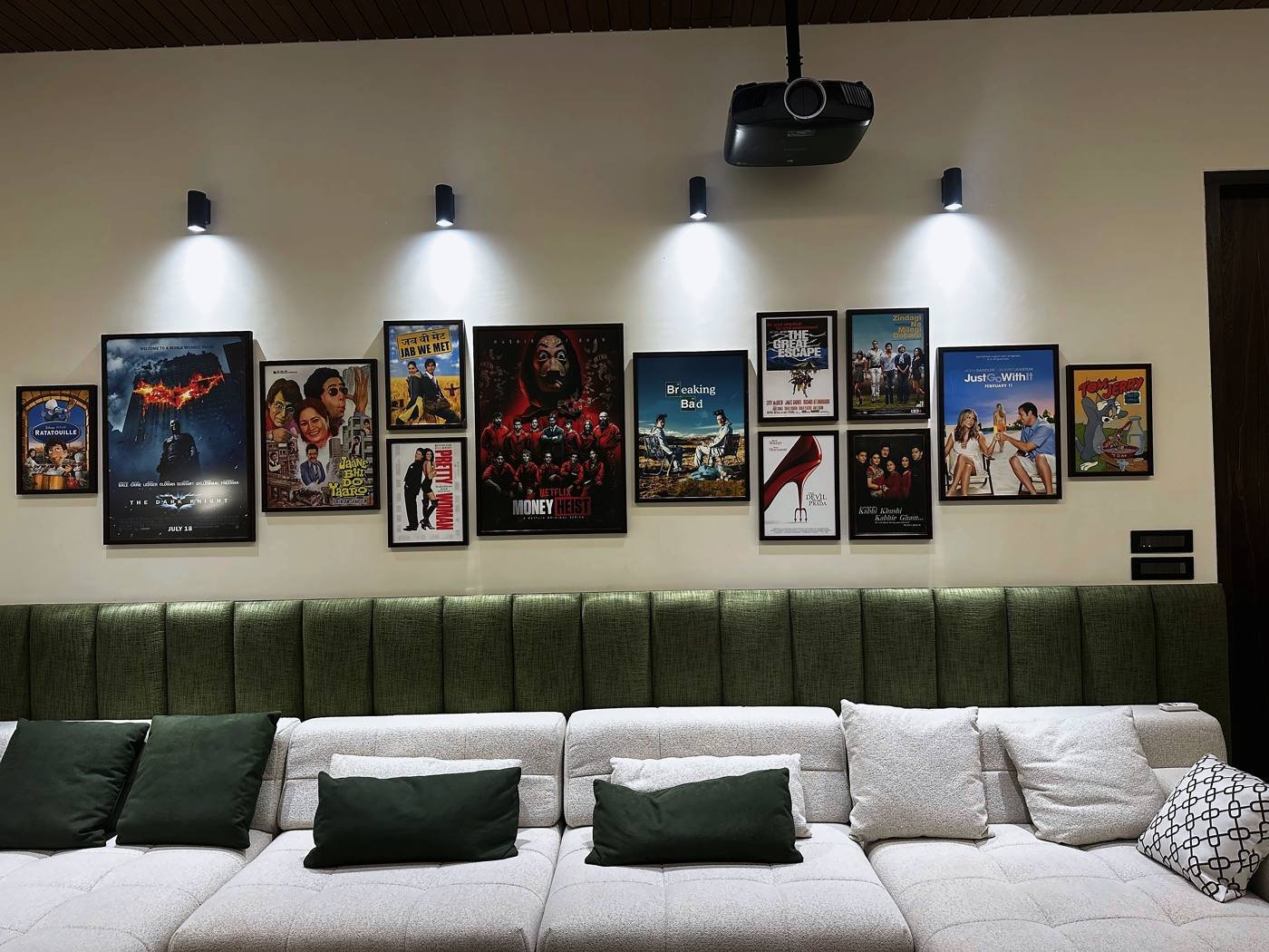 Film poster gallery wall above the theatre seating