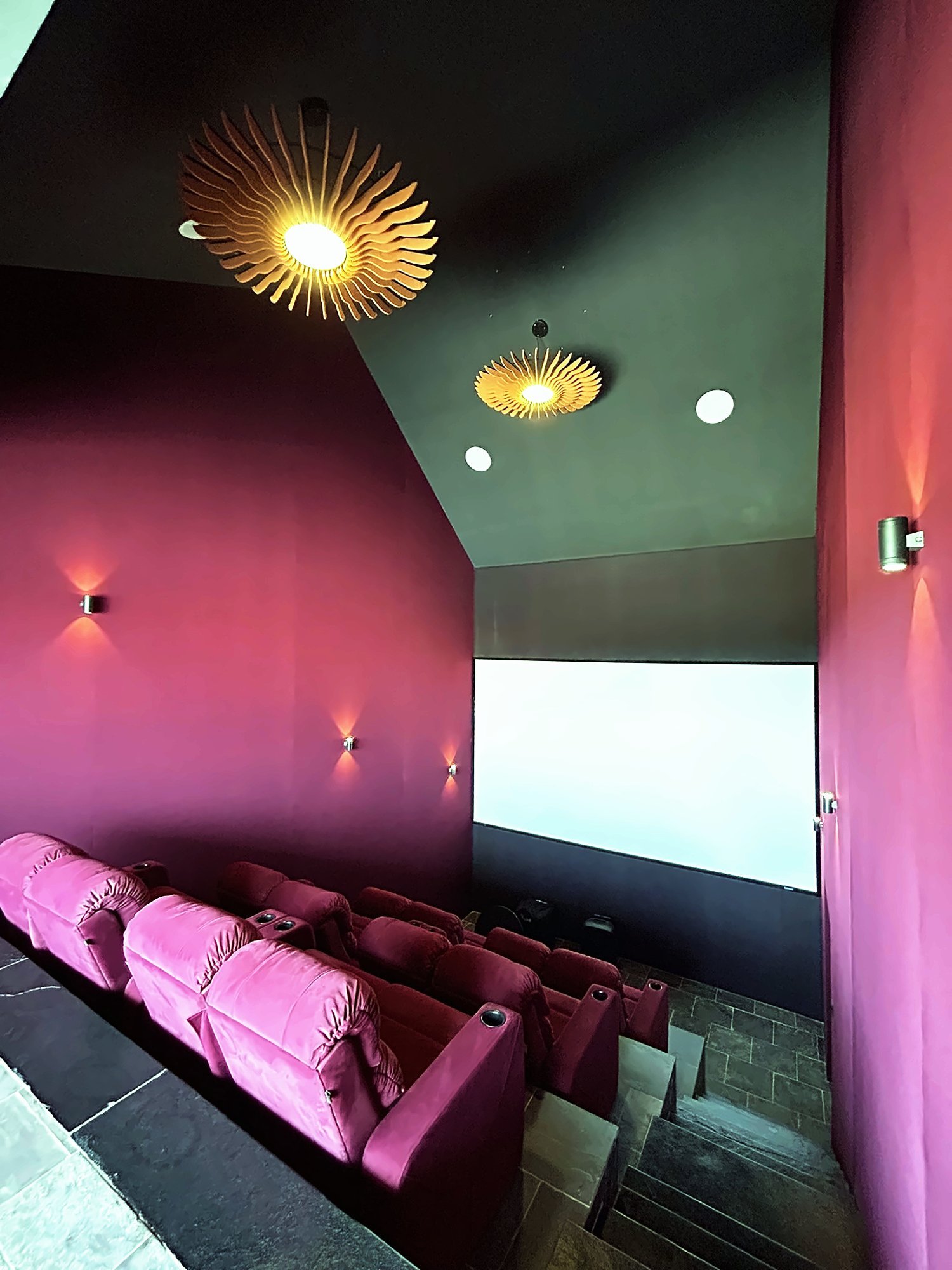 Home theatre seen from the entrance with a sculptural pendant light