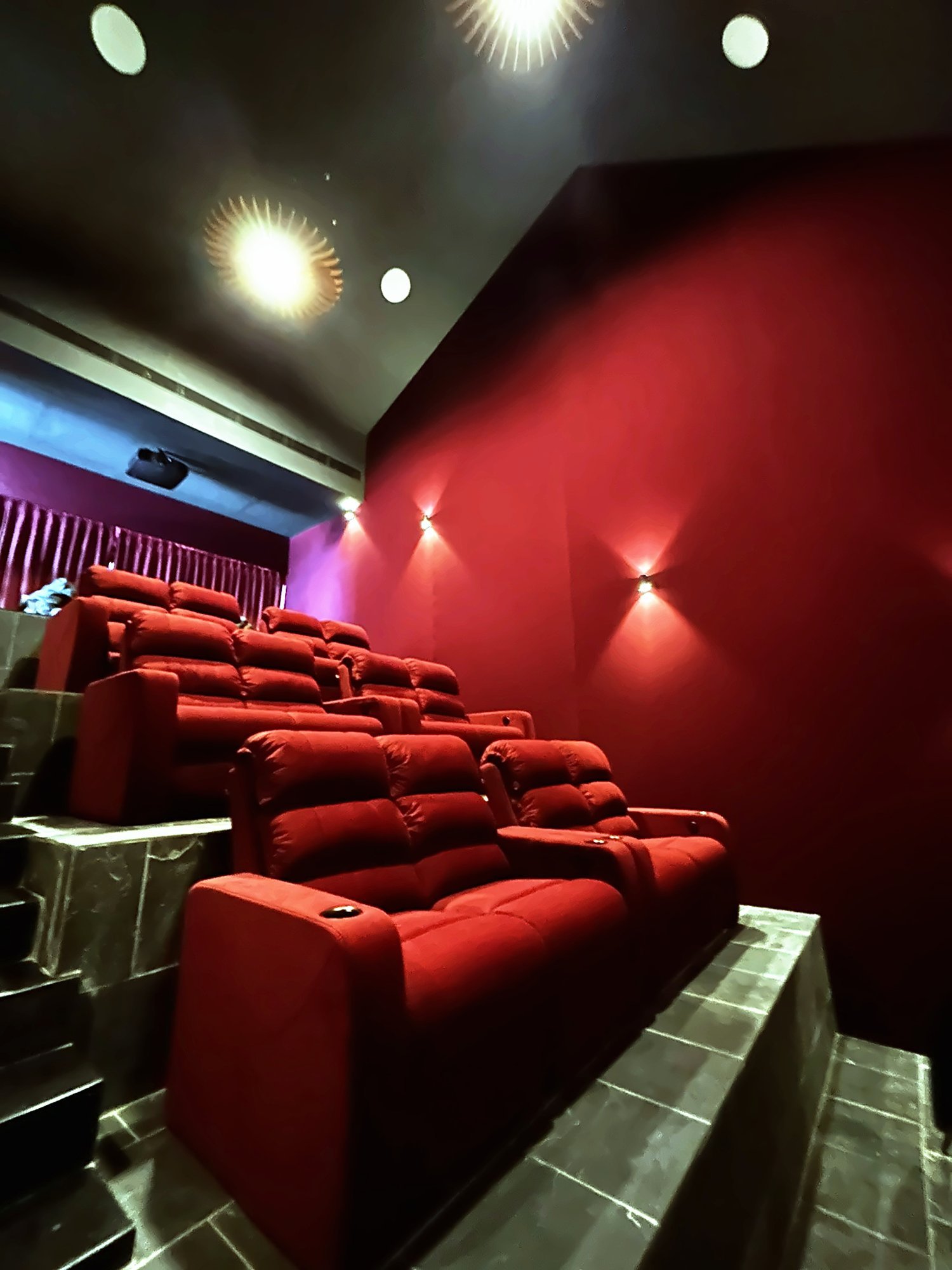 Tiered red recliners in a home theatre