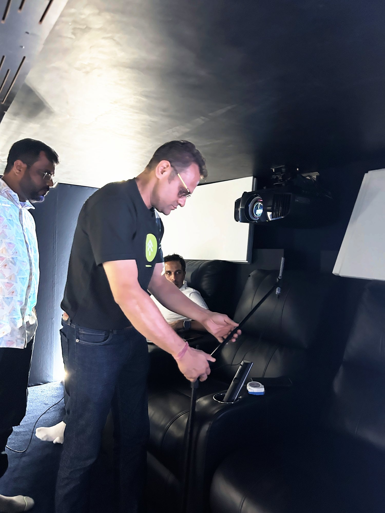 Participant tuning an audio system inside a dedicated theatre room