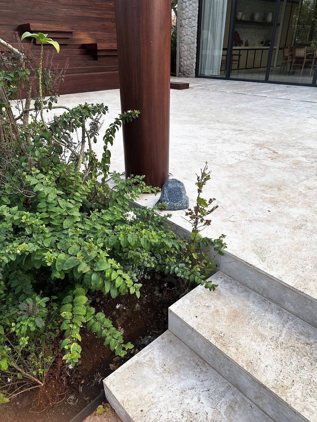 Stone-shaped outdoor speaker in the garden planting