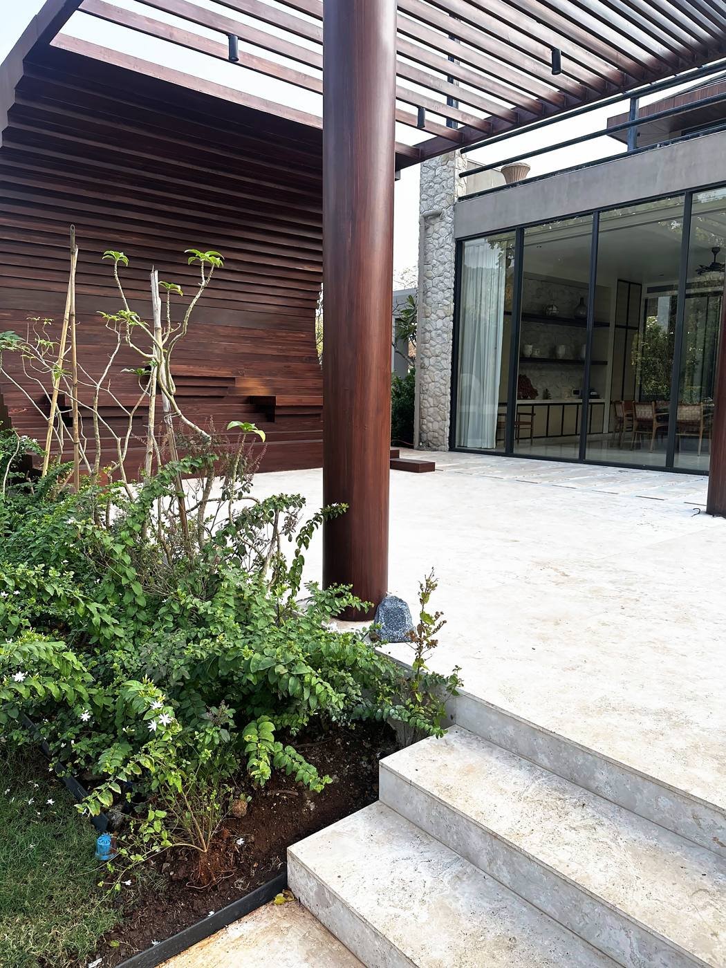Travertine terrace and pergola with hidden outdoor audio