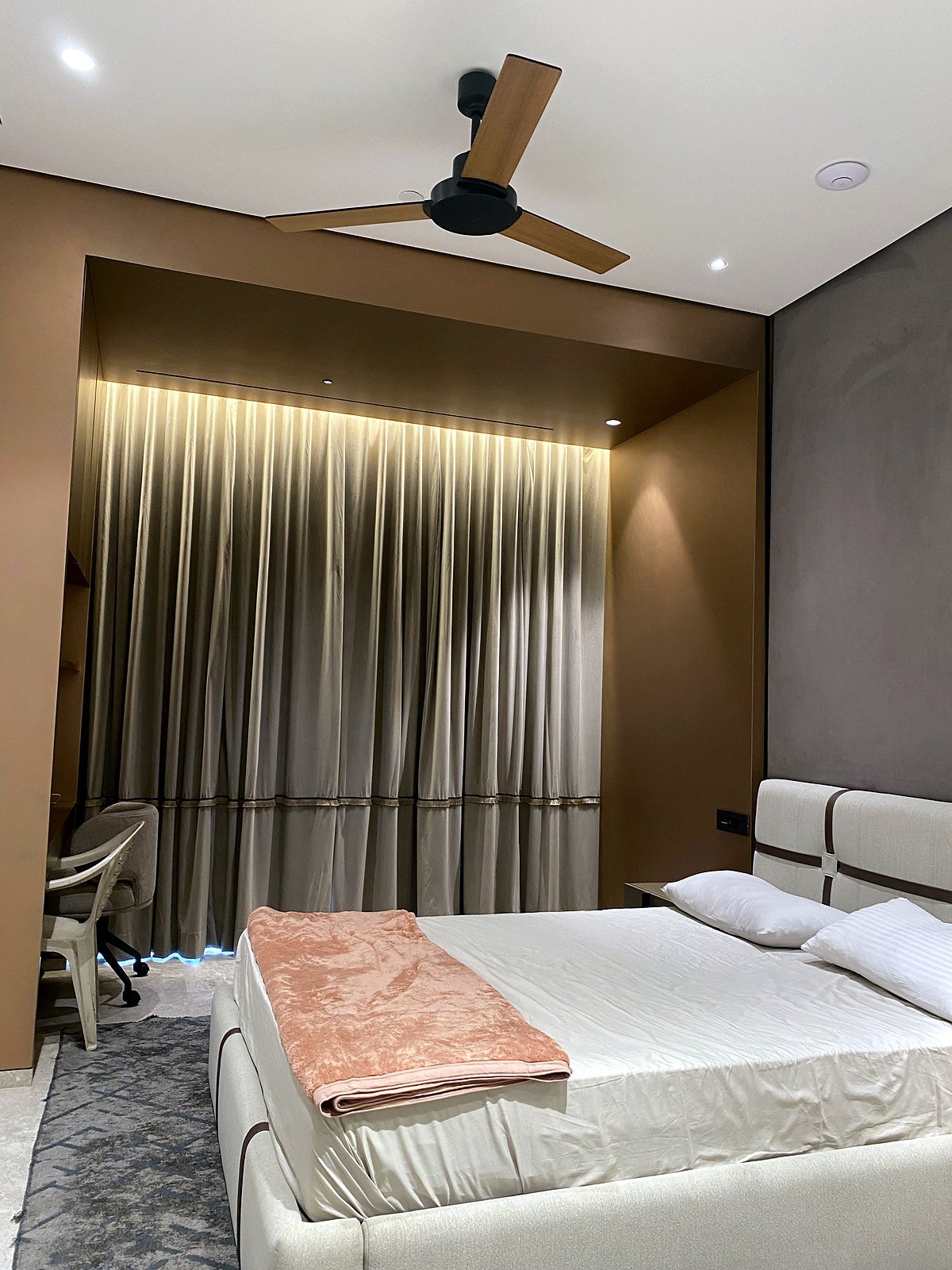 Bedroom in a Bandra apartment with a curtain recess and cove lighting
