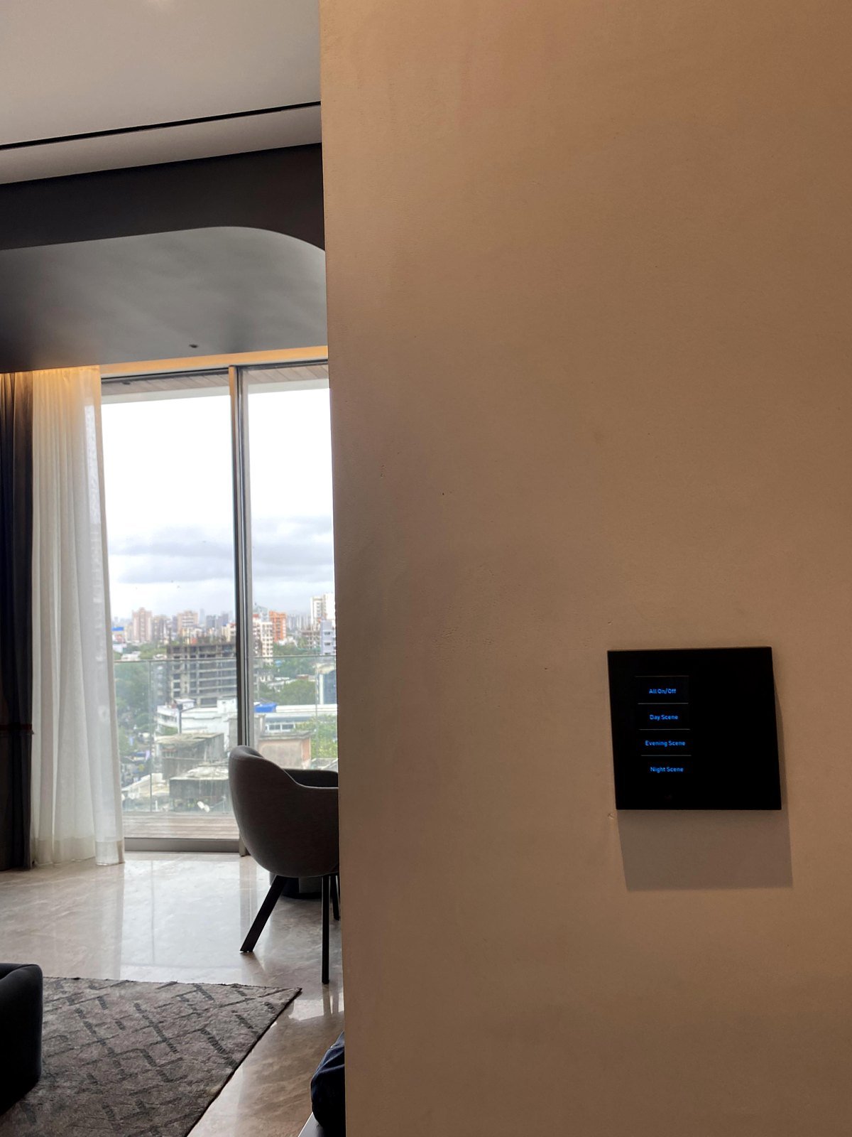 Touch-display keypad on a wall beside a window in a Bandra apartment