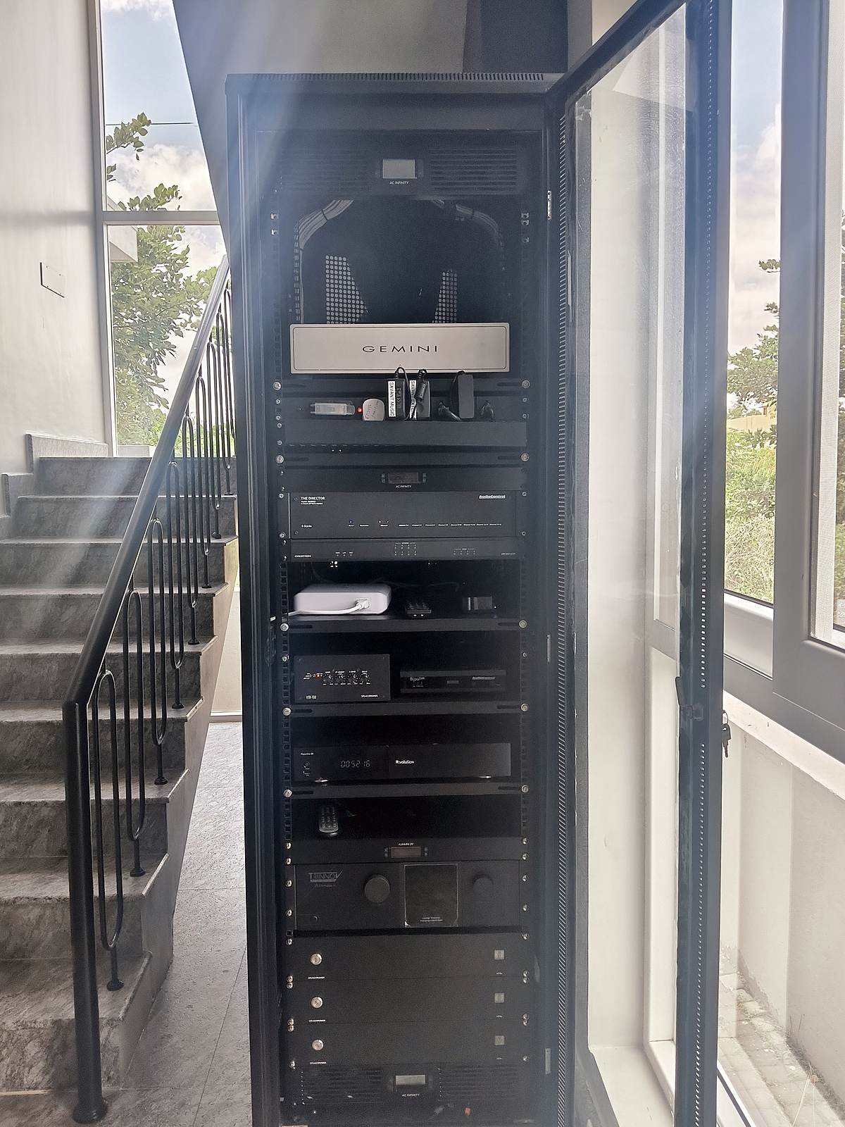 Floor-standing AV equipment rack with amplifiers and processors at the Devanahalli experience centre