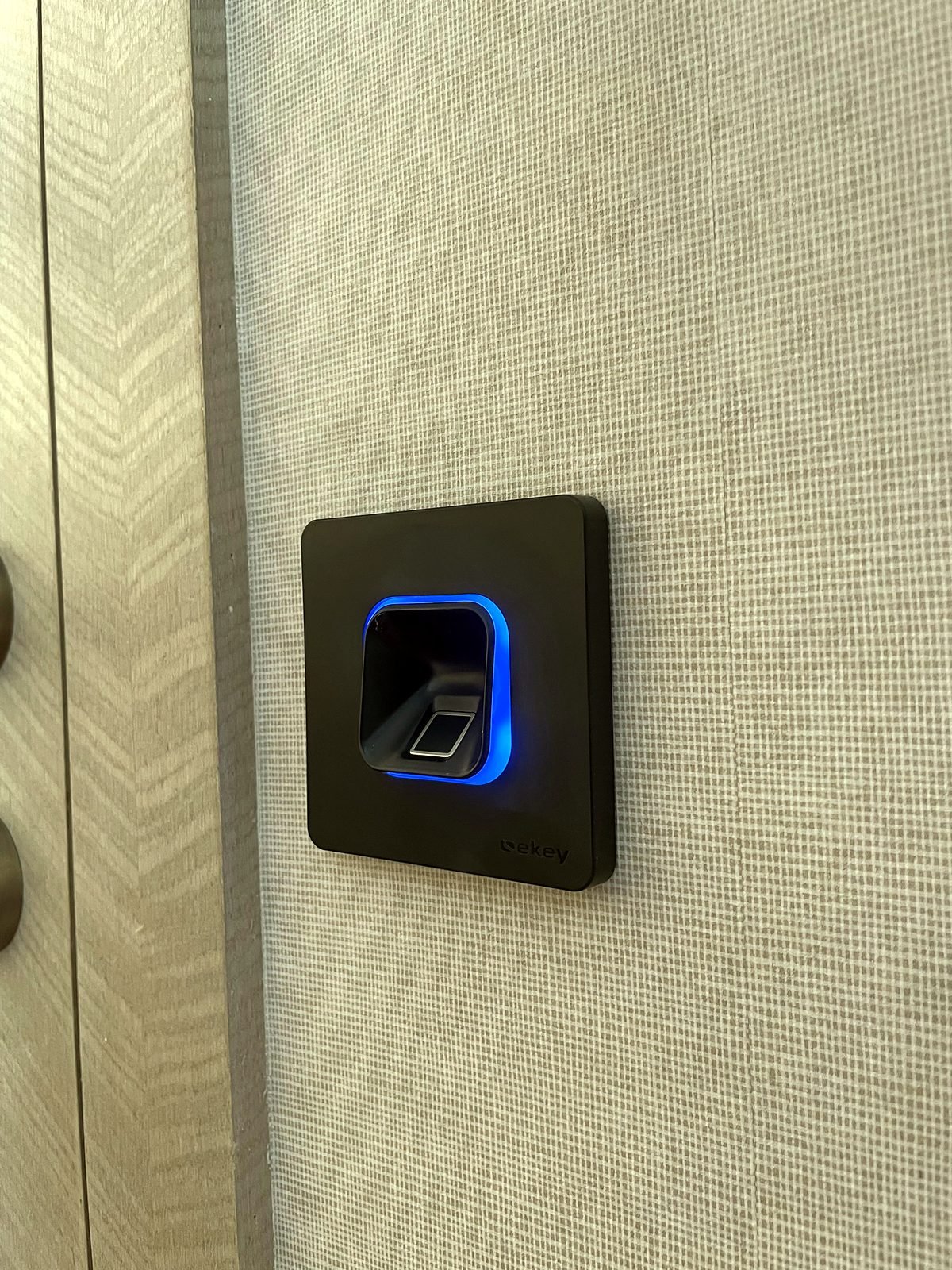 Ekey fingerprint reader beside a door in a Cuffe Parade apartment