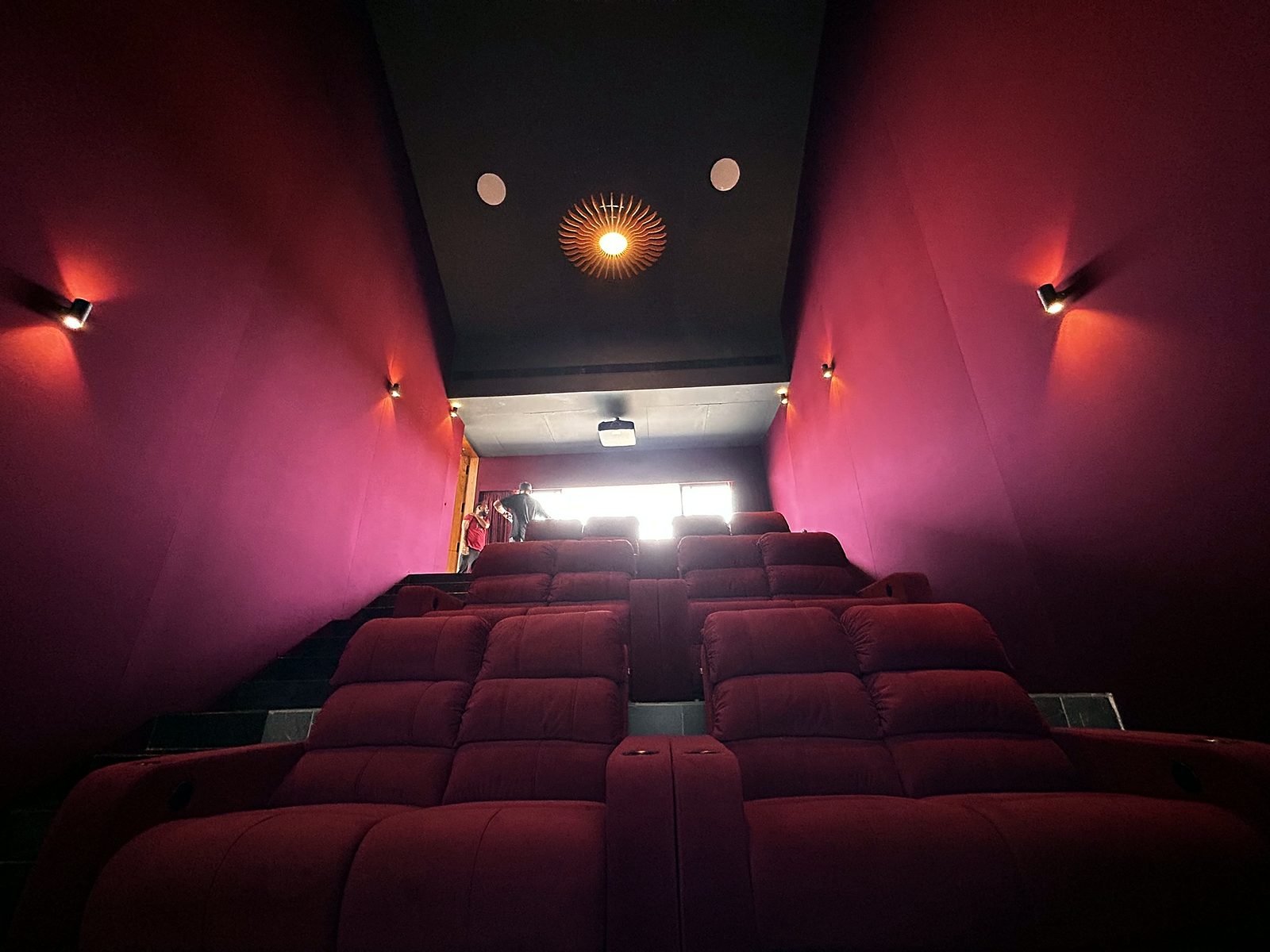 View up the tiered seating rows of a home theatre in a Goa villa