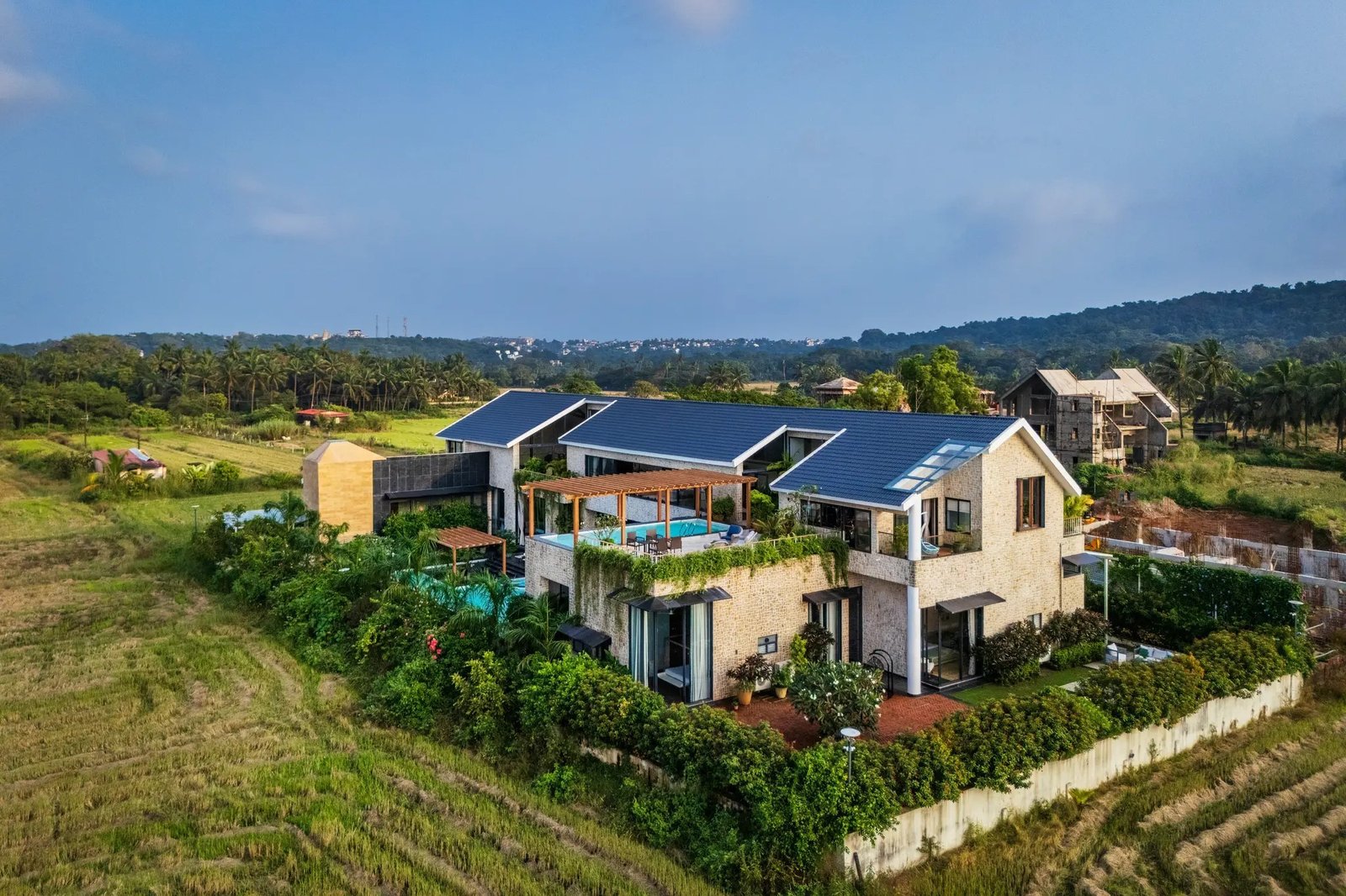 Aerial view of a luxury villa in Goa with a rooftop pool, home theatre and smart home by Avenue Sound
