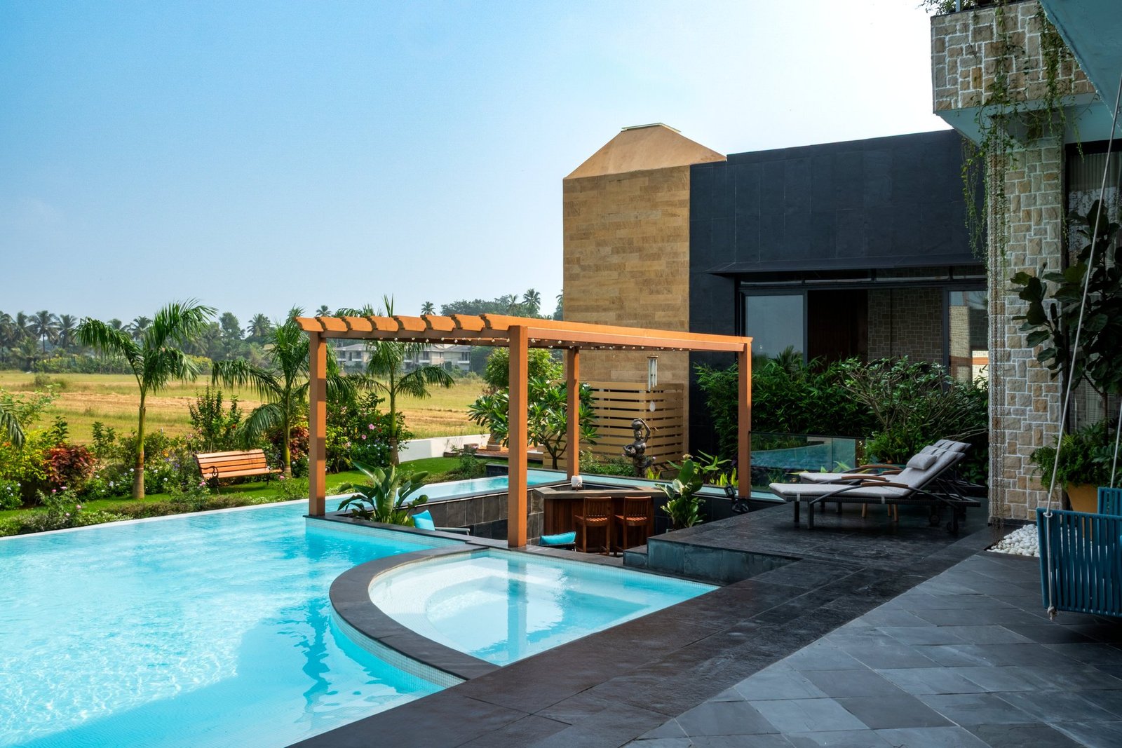 Swimming pool and shaded seating in a Goa villa garden