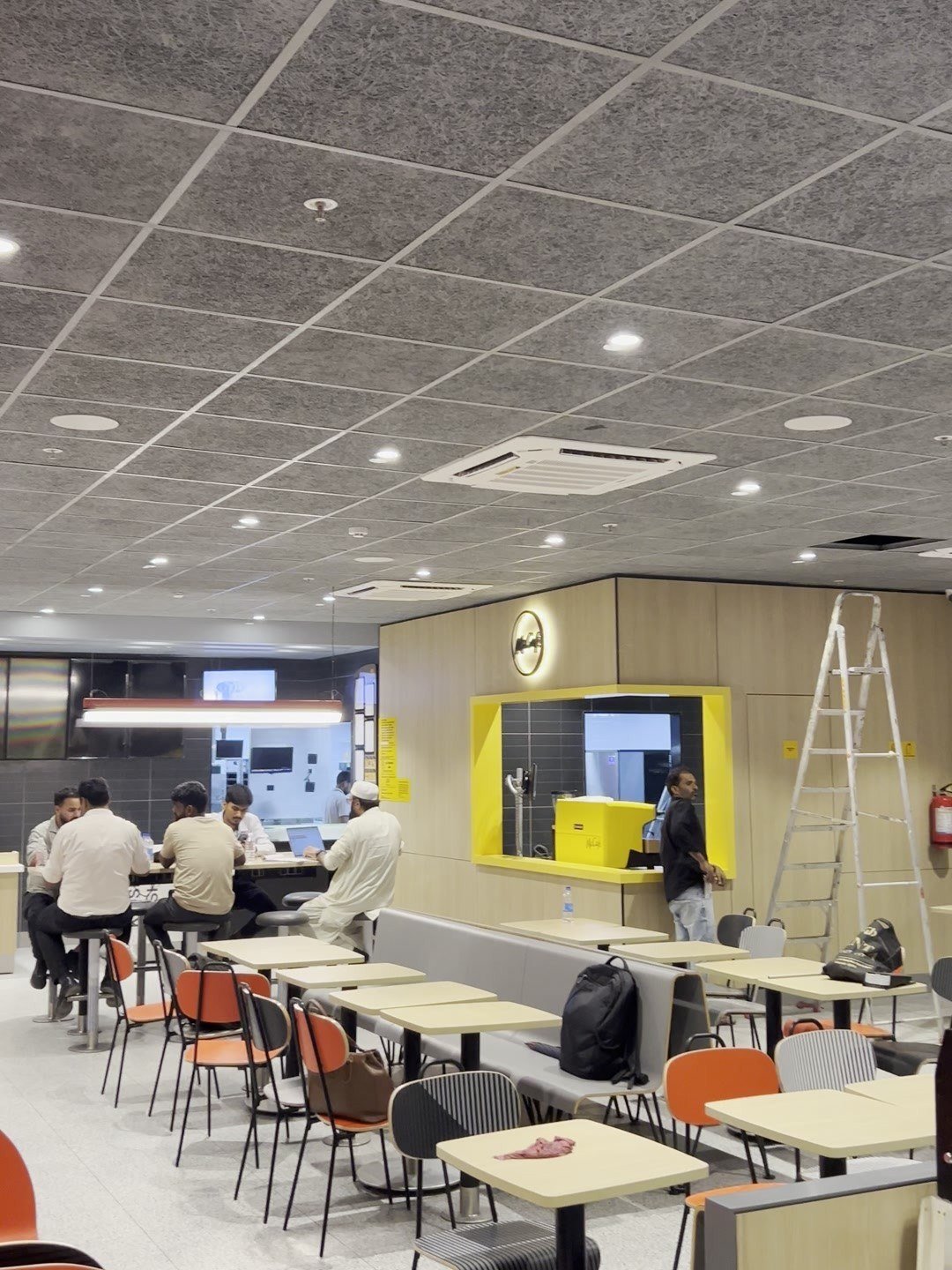 Seating area of a restaurant for McDonald's India with ceiling speakers and lighting