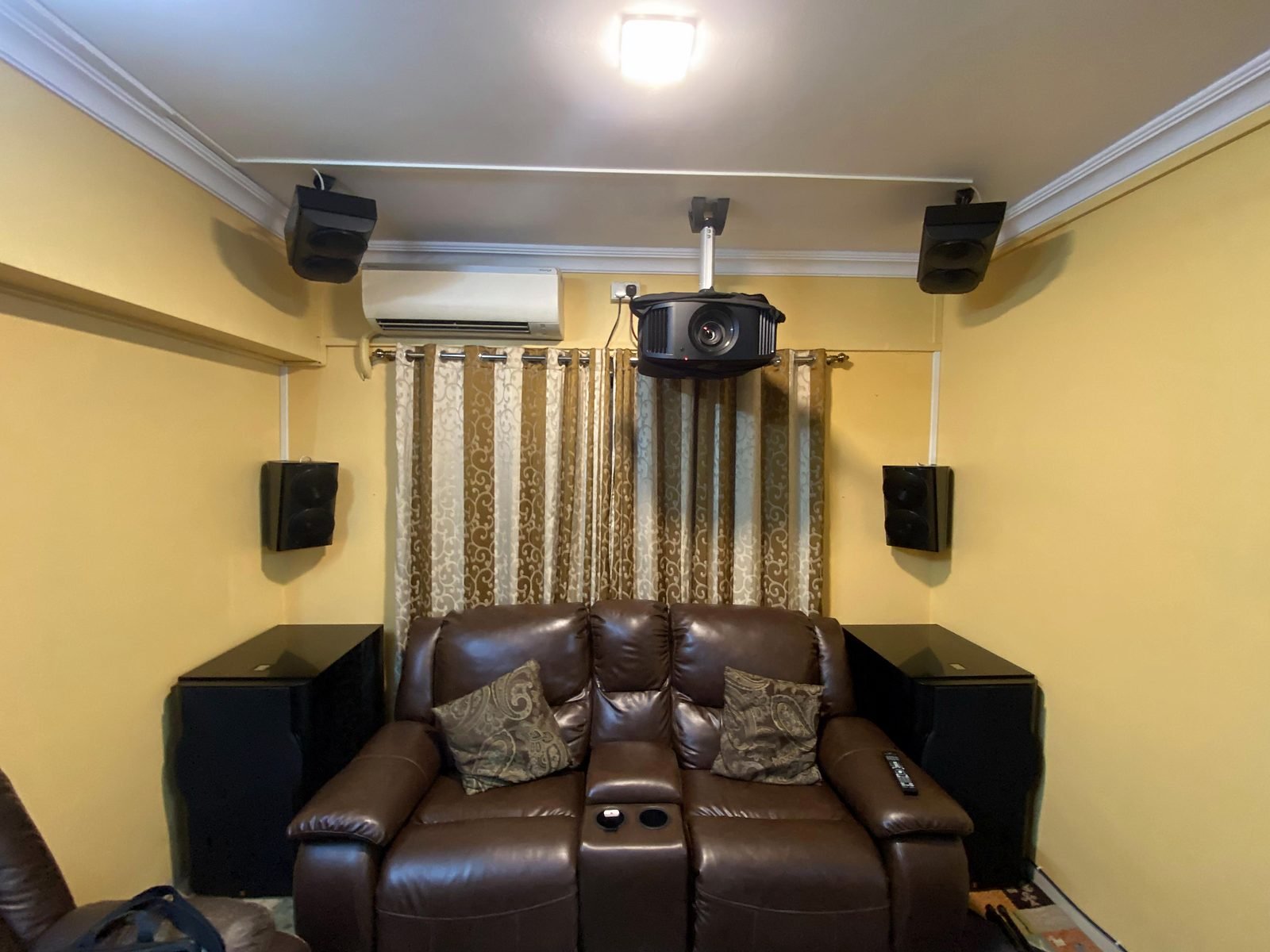 Seating area and surround speakers in a Sanpada home theatre